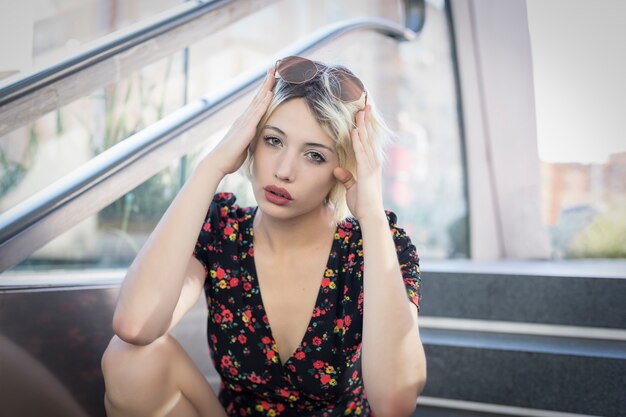 Portrait of a blonde girl on the stairs of a subway