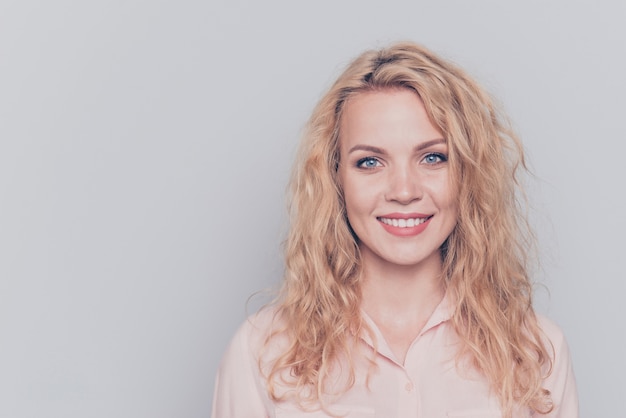 Portrait of blonde girl wearing casual shirt isolated on grey