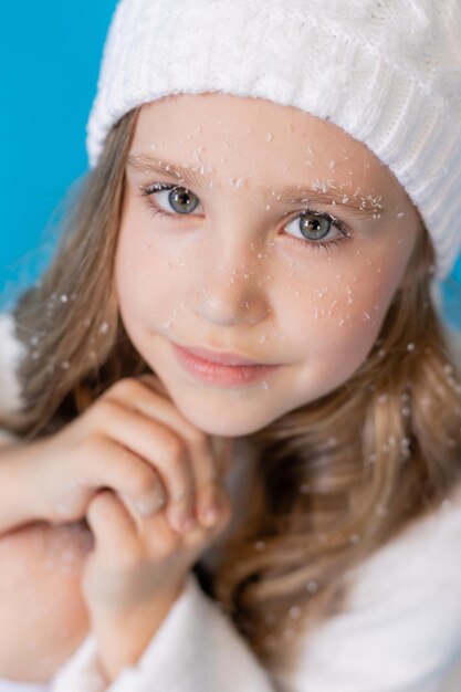 portrait of a blonde girl in a winter knitted hat