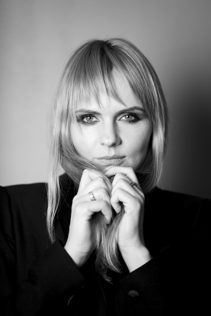 Portrait of a blonde in a jacket. Photo in black and white style