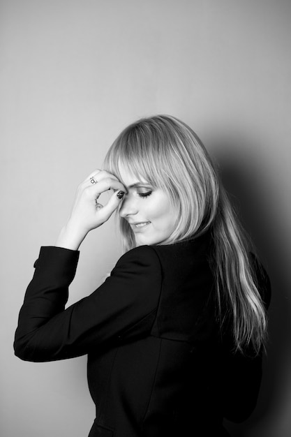 Portrait of a blonde in a jacket. Photo in black and white style