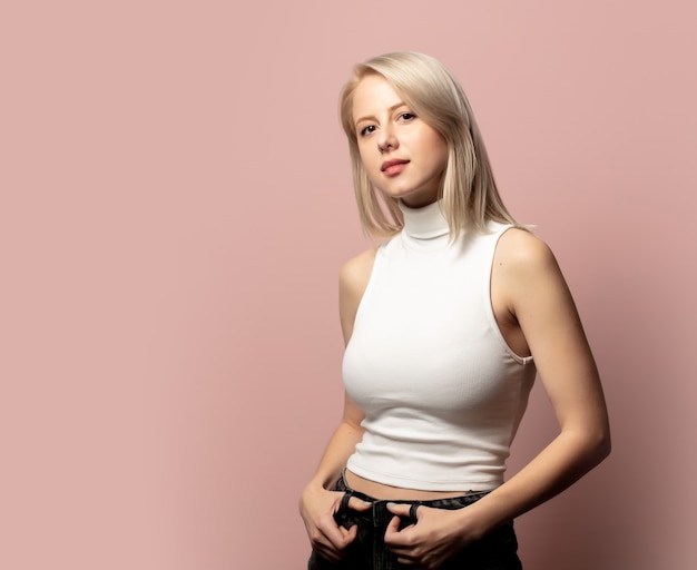 Portrait of blonde in top on pink