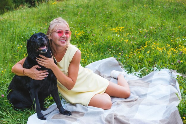 Portrait of blonde woman and dog