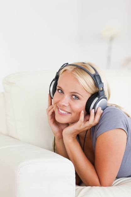 Portrait of a blonde woman listening to music