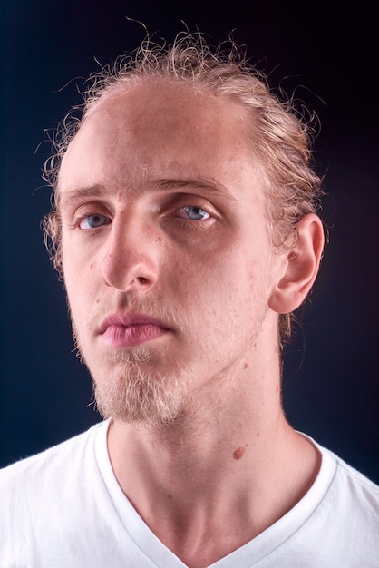 Portrait of a blonde young man with blue eyes