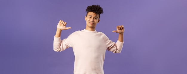 Portrait of boastful handsome young male student with dreads bragging about how he workout in gym sh