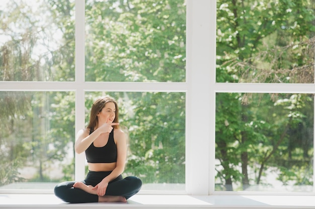 Portrait of body fitness trainer lady relaxing between exercise on gym