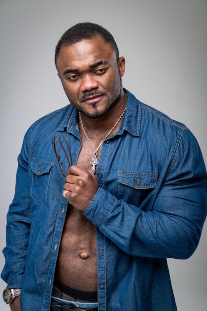 Portrait of a bodybuilder african american in studio Strong handsome man posing Athlete fashionable male