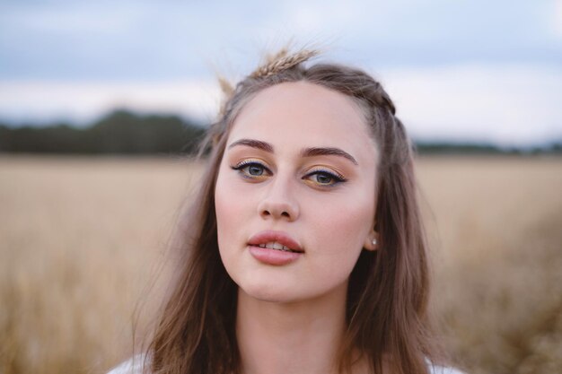 Portrait of bohemian girl posing over wheat field