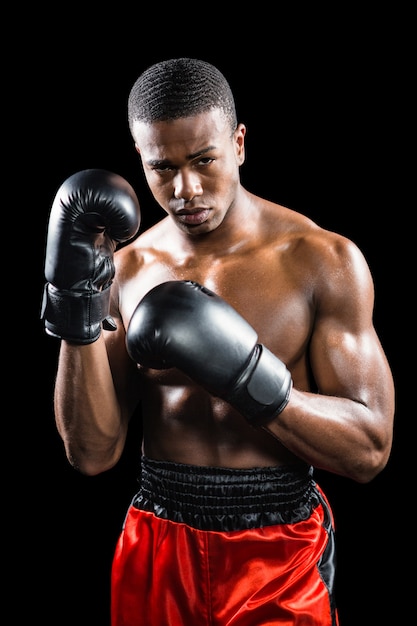 Portrait of boxer performing uppercut