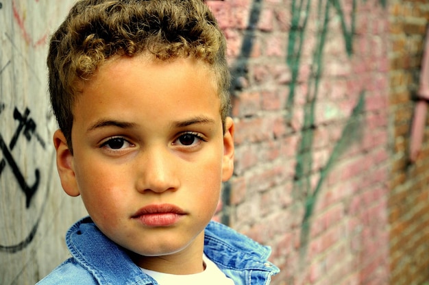 Portrait of boy against brick wall