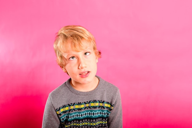 Portrait of boy against pink background