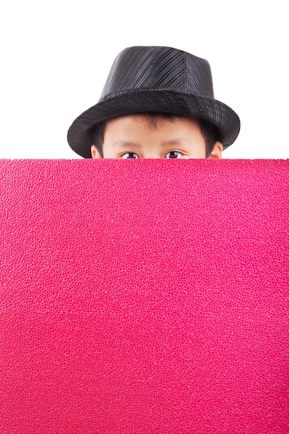 Photo portrait of boy face covered with red paper against red background