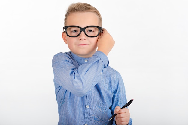 Portrait a boy in glasses with a pen in a white isolated background