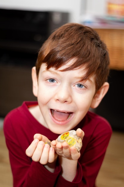 Portrait of boy holding stones