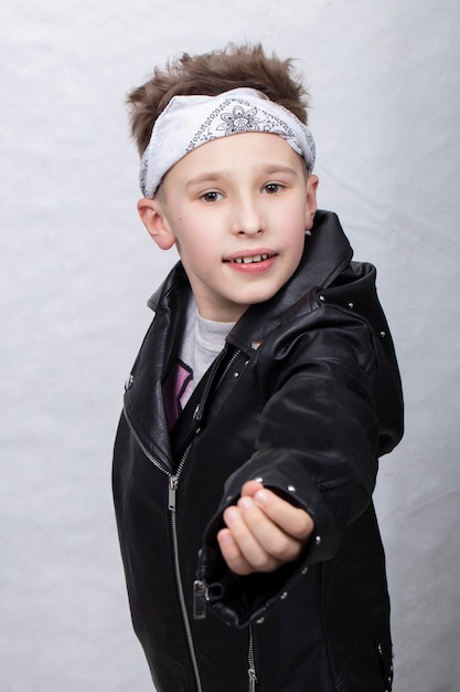 Portrait of a boy in a leather jacket and a bandage on his head He smiles at the camera