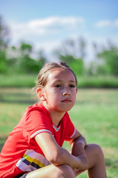 Portrait of boy looking away while sitting on land