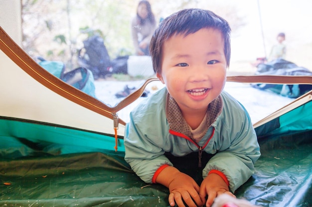 Portrait of boy lying in tent