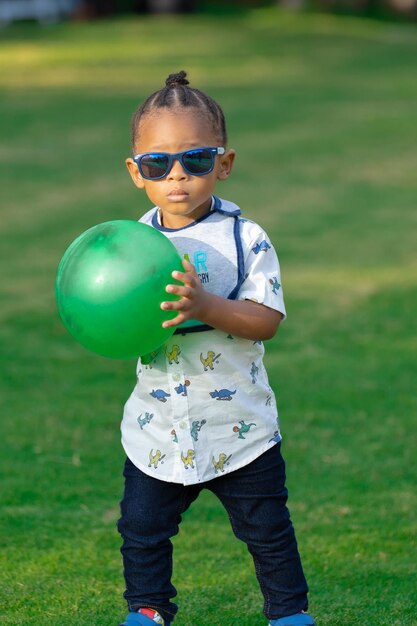 Portrait of boy playing with ball