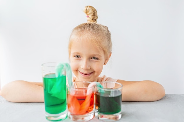 Photo portrait of boy playing with drinking glass against white background