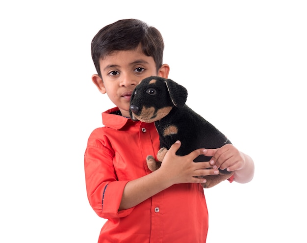 Portrait of boy playing with his stuffed animal pet on white background