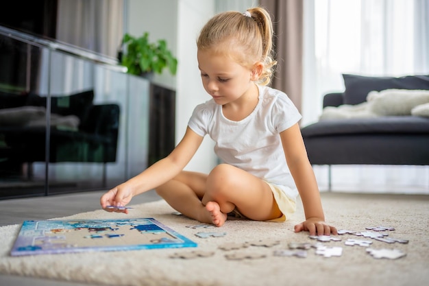 Photo portrait of boy playing with toy blocks at home