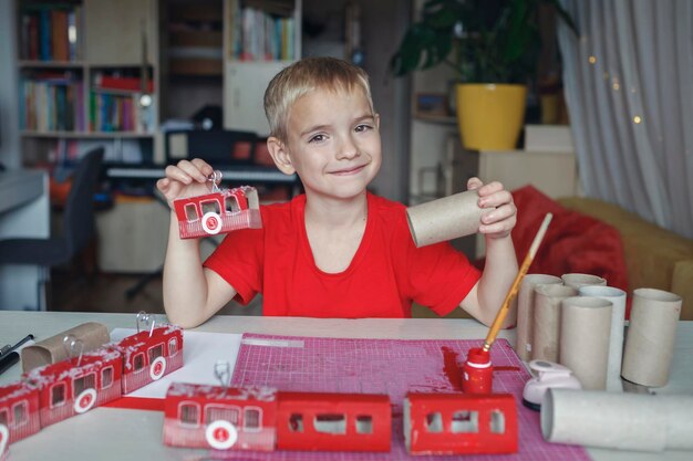 Photo portrait of boy playing with toy blocks while sitting at home