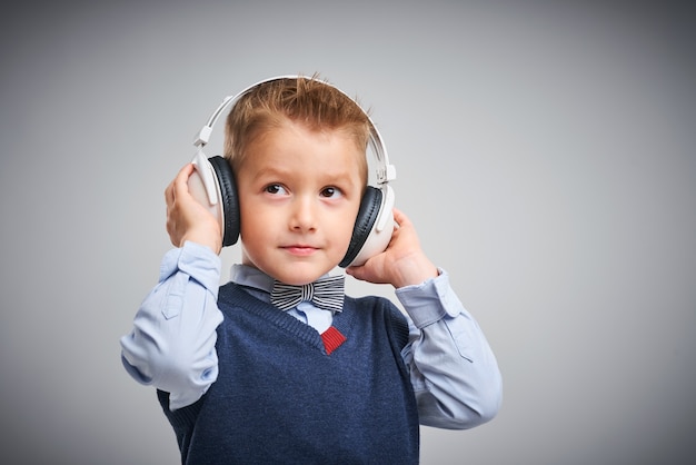 Portrait of a boy posing over white with headphones