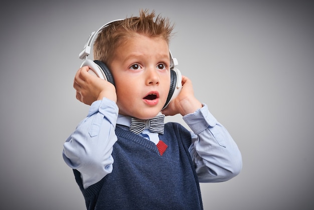 Portrait of a boy posing over white with headphones