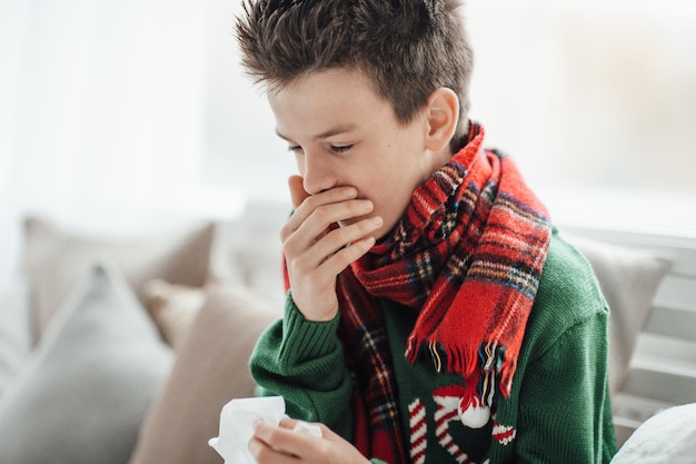 Portrait of boy sitting on sofa