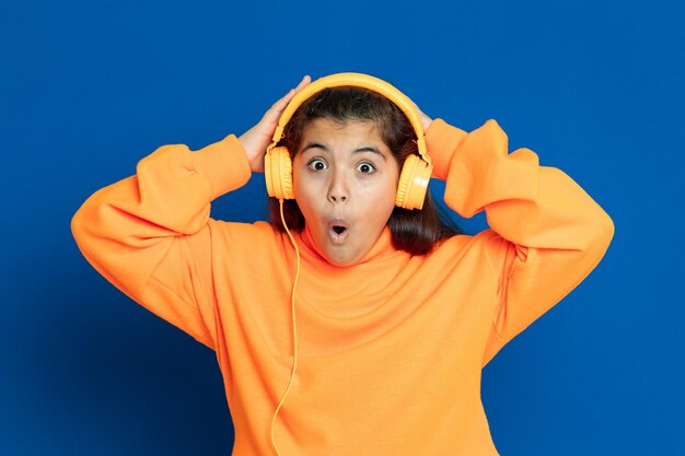 Portrait of boy standing against blue background