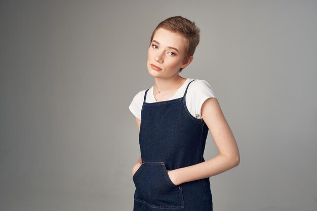 Portrait of boy standing against gray background