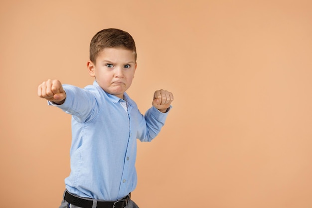 Portrait of boy standing against wall