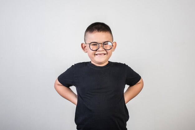 Portrait of boy standing against white background