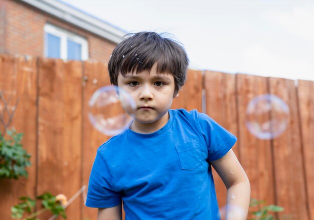 Portrait of boy standing in front of building