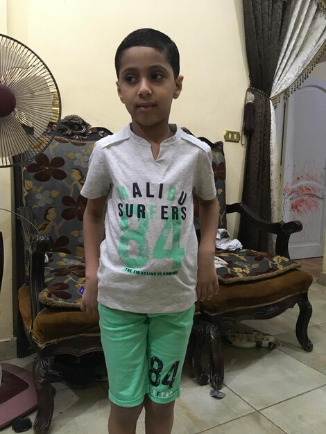 Portrait of boy standing at home