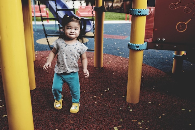 Photo portrait of boy standing on slide