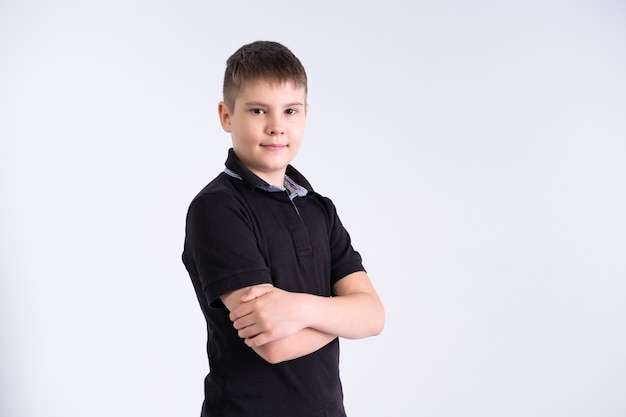 Portrait of boy teenager in black t-shirt smiling with positive feeling on his face on white