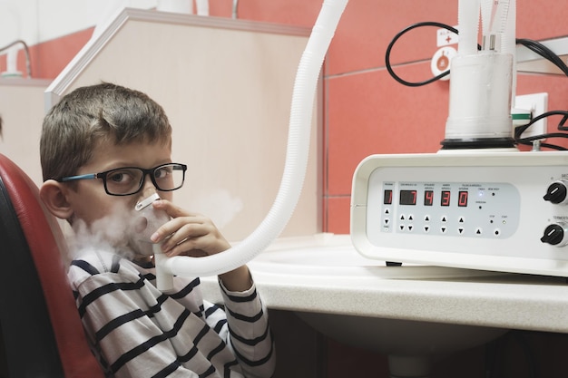 Portrait of boy wearing oxygen mask in hospital