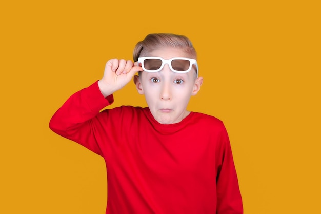 Portrait of boy wearing sunglasses against yellow background