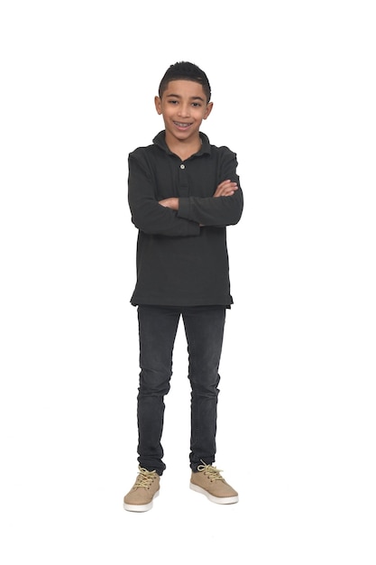 Portrait of boy with arms crossed looking at camera on white background