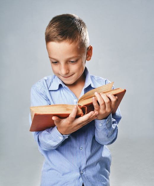 A portrait of a boy with a big book