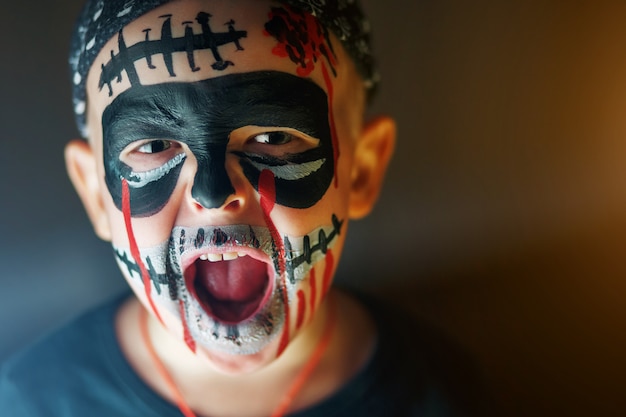 Photo portrait of a boy with screaming emotions on halloween