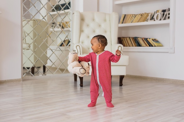 Photo portrait of boy with toy on floor at home