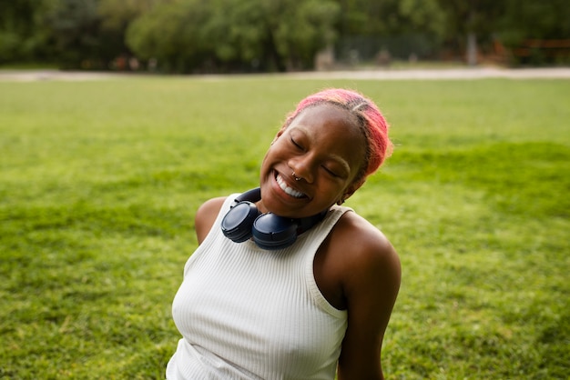 Portrait of braless woman outdoors with headphones