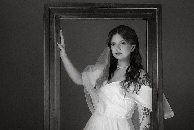 Portrait of a bride girl with red hair in a white wedding dress