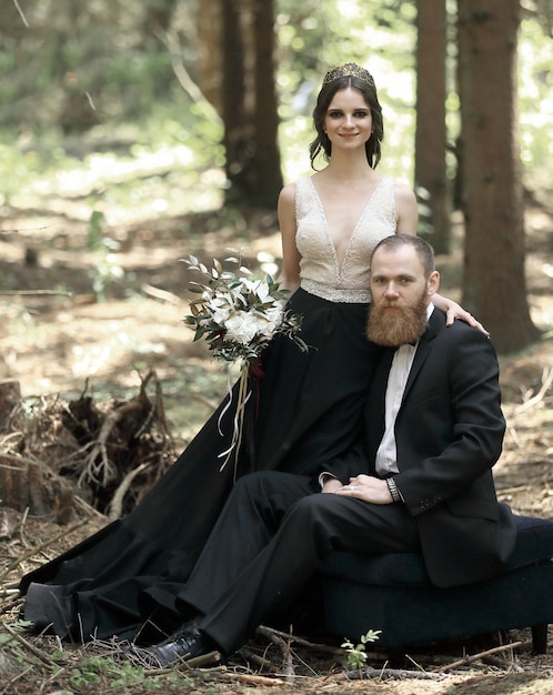 Portrait of a bride and groom in a pine forest.