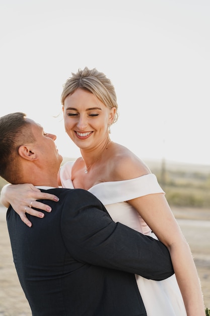 Portrait of a bride and groom in a sunset light