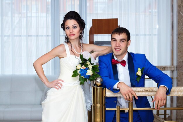 Portrait of the bride and groom at their wedding indoors