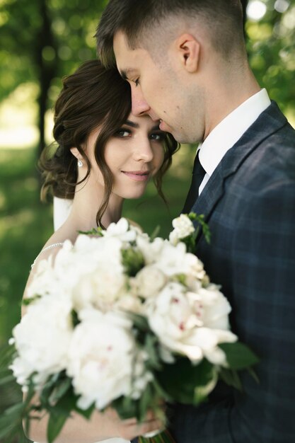 Portrait of the bride and groom on a walk in the woods